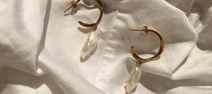 Pearl drop gold hoop earrings in the sunshine